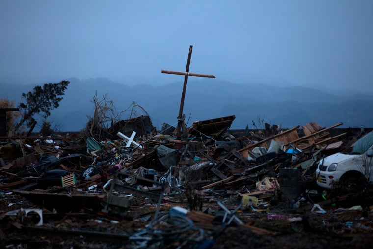 Image: A cross stands in the debris where a church used to be